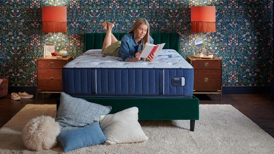 Blonde woman relaxes on the Stearns & Foster Estate Mattress