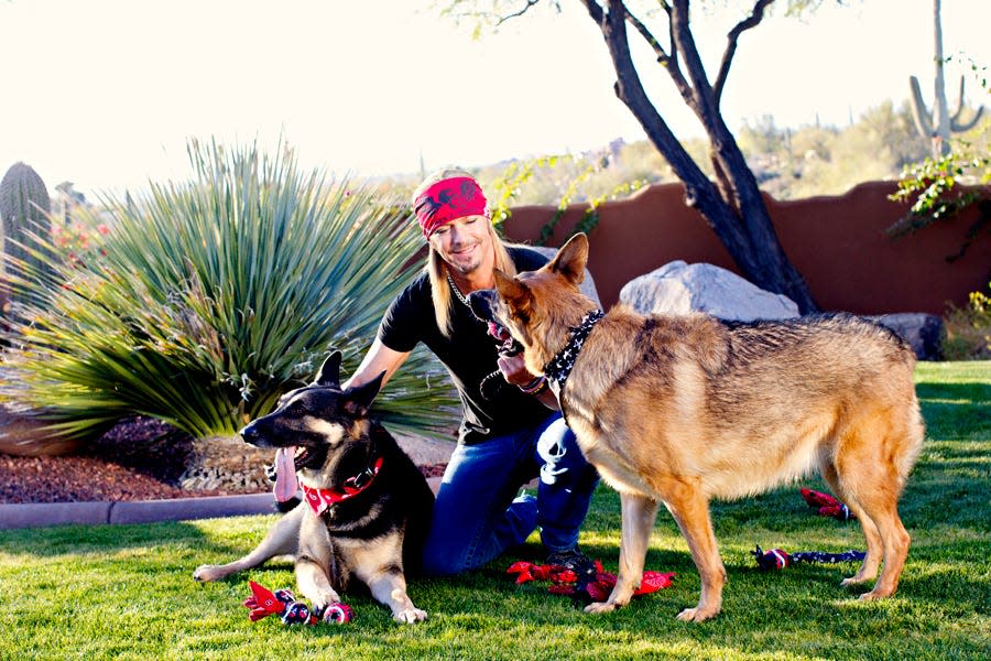 Rock musician Bret Michaels is adopting a rescue dog in Nebraska named after him. He's seen here with his dogs, Diesel and Phoenix.