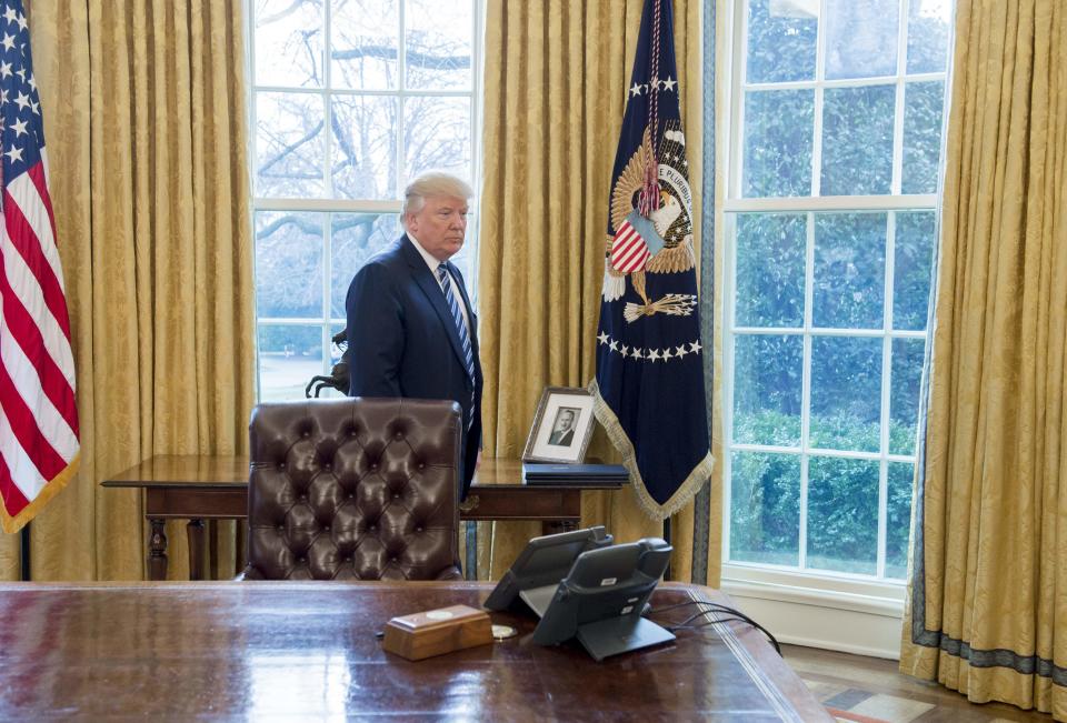 A photograph of President Donald Trump's father, Fred Trump, sits behind the Resolute Desk in the Oval Office.