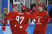 Ice Hockey – Pyeongchang 2018 Winter Olympics – Men Preliminary Round Match – Olympic Athletes from Russia v Slovenia - Gangneung Hockey Centre, Gangneung, South Korea – February 16, 2018 - Kirill Kaprizov, an Olympic Athlete from Russia, celebrates his goal with teammates Nikita Gusev and Artyom Zub. REUTERS/Kim Kyung-Hoon