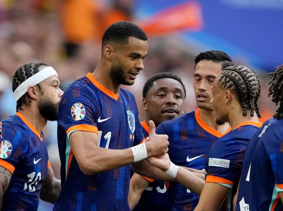 Cody Gakpo celebrates with Xavi Simons after scoring the first Netherlands goal in Munich’s Allianz Arena  (Reuters)