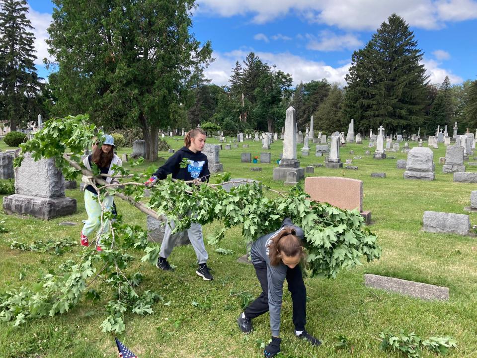 Girl Scouts from Geneseo, Boy Scouts and other volunteers helped to clean up Temple Hill Cemetery in Geneseo, Livingston County, after a wind storm toppled trees on June 16, 2022.