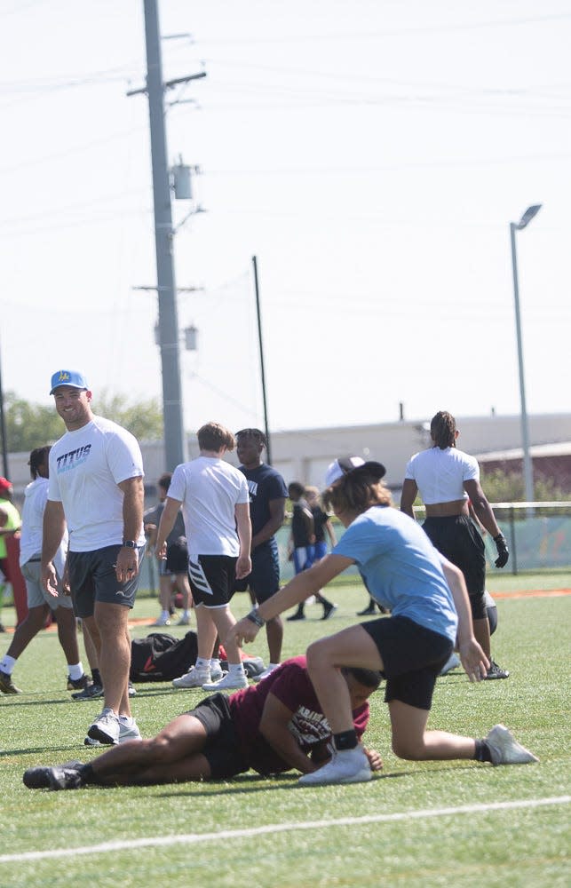 Troy Reeder, left, of the LA Chargers looks on during drills at a free NFL clinic for youths at Chase Fieldhouse in Wilmington on Friday, June 17, 2022.