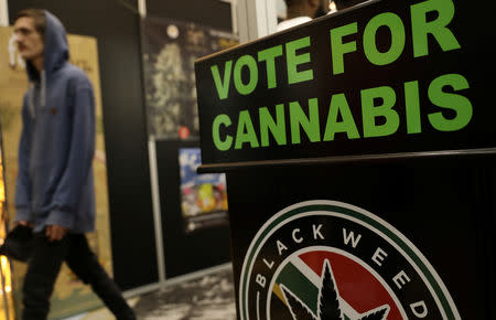 A guest walks past a poster during the opening of the four-day Cannabis expo in Pretoria, South Africa, December 13, 2018. REUTERS Siphiwe Sibeko