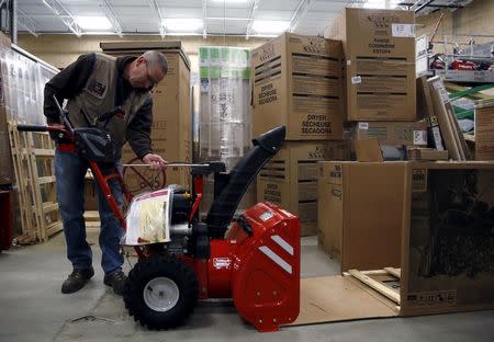 Troy-Bilt representative David Bowles assembles a snow blower at the Lowe's store in Kentlands, Maryland January 21, 2016. REUTERS/Gary Cameron