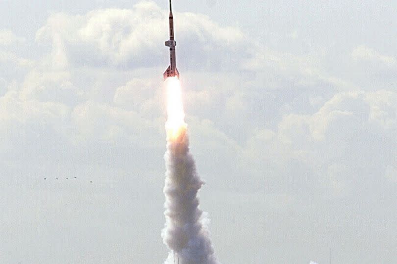 Spectators watch as Steve Bennett's home made Starchaser 3a rocket blasts off from the sands of Morecambe Bay in Lancashire in 1999