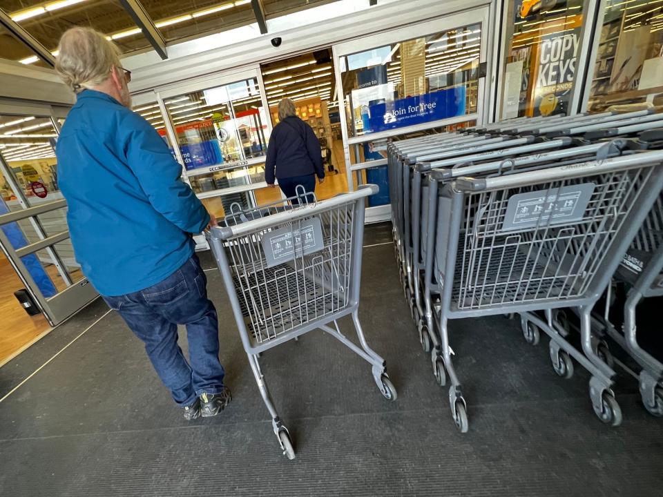 A shopper collects a shopping cart at a Bed Bath & Beyond store