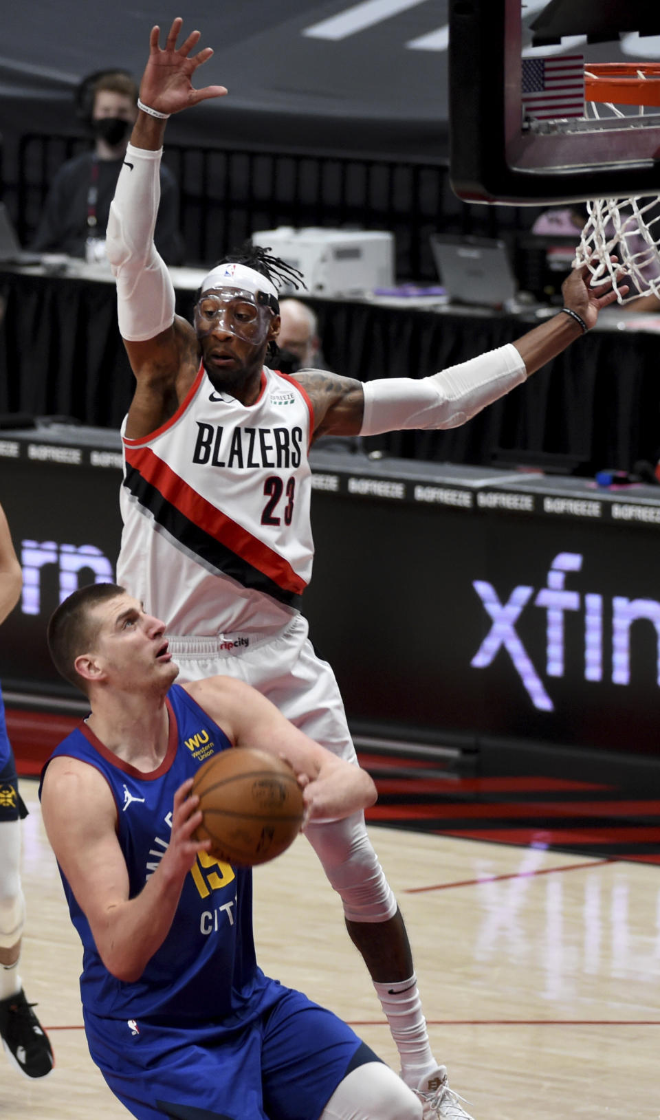 Denver Nuggets center Nikola Jokic is defended by Portland Trail Blazers forward Robert Covington during the first half of an NBA basketball game in Portland, Ore., Wednesday, April 21, 2021. (AP Photo/Steve Dykes)