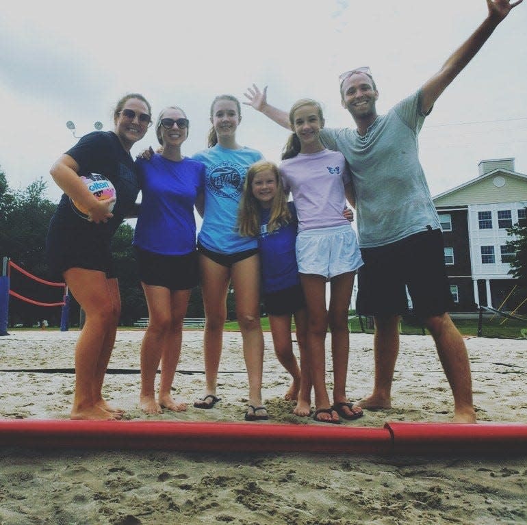 Chris Bryant, right, at a Solo Parent Society beach volleyball outing he organized last year at the Williamson County rec center. From left, single parents Staci McNeely and Joni Patrick and Patrick's three children