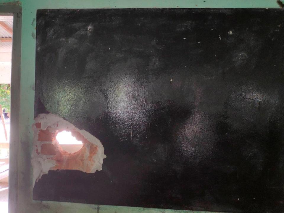 A damaged blackboard is seen at a local school that was hit by an air attack (via REUTERS)