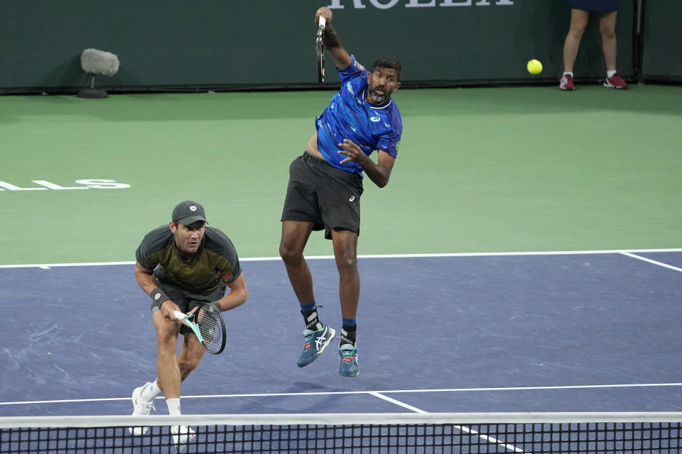 Rohan Bopanna, of India, right, returns a shot next to teammate Matthew Ebden, of Australia, during the men's doubles final against Wesley Koolhof, of the Netherlands, and Neal Skupski, of Britain, at the BNP Paribas Open tennis tournament Saturday, March 18, 2023, in Indian Wells, Calif. (AP Photo/Mark J. Terrill)