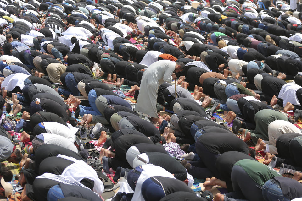 Supporters of the Shiite cleric Muqtada al-Sadr hold prayer near the parliament building in Baghdad, Iraq, Friday, Aug. 12, 2022. Al-Sadr's supporters continue their sit-in outside the parliament to demand early elections. (AP Photo/Anmar Khalil)