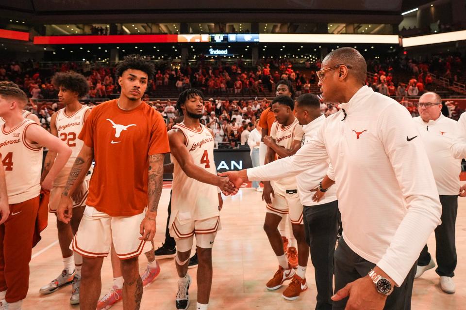 Texas guard Tyrese Hunter shakes hands with head coach Rodney Terry after Monday's 62-56 home win over Kansas State. Terry says Hunter's defensive intensity will be crucial in Texas' march to the postseason.