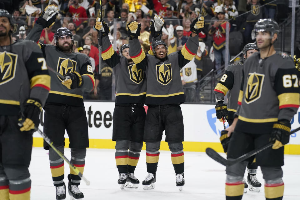 Vegas Golden Knights center William Karlsson, center left, and Vegas Golden Knights right wing Keegan Kolesar, center right, celebrate with teammates after defeating the Colorado Avalanche in Game 6 of an NHL hockey Stanley Cup second-round playoff series Thursday, June 10, 2021, in Las Vegas. (AP Photo/John Locher)
