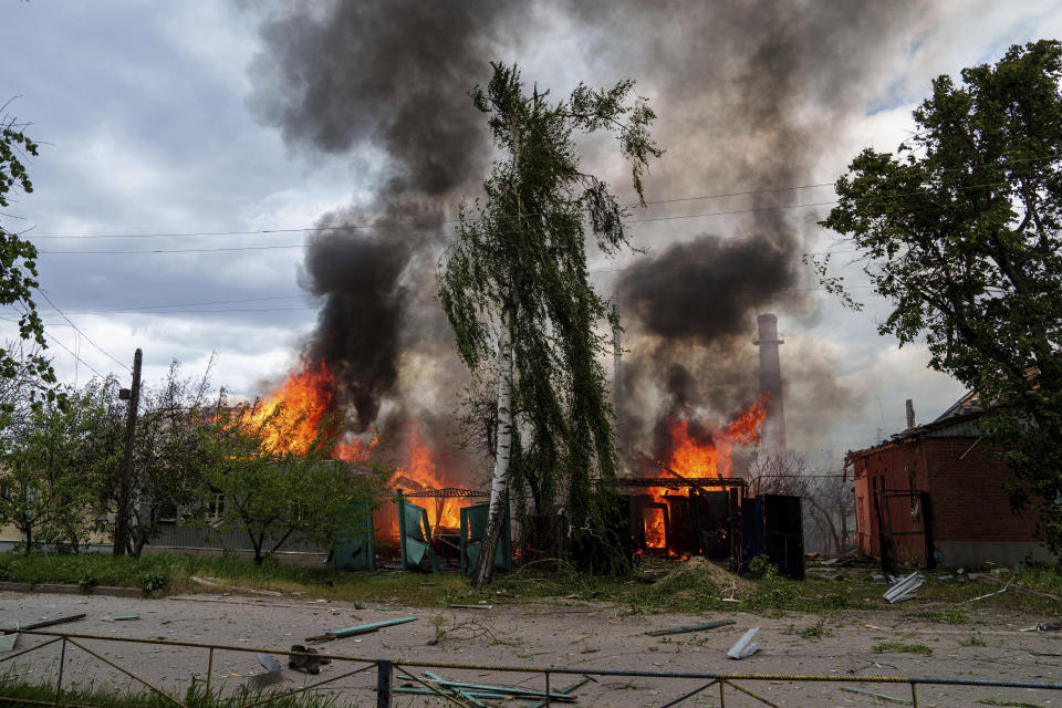 Residential houses on fire after Russian airstrikes in Vovchansk, Ukraine, on Saturday, May 11, 2024. (AP Photo/Evgeniy Maloletka)