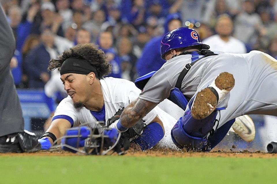The Dodgers' Miguel Vargas beats the tag of Cubs catcher Tucker Barnhart for the winning run.