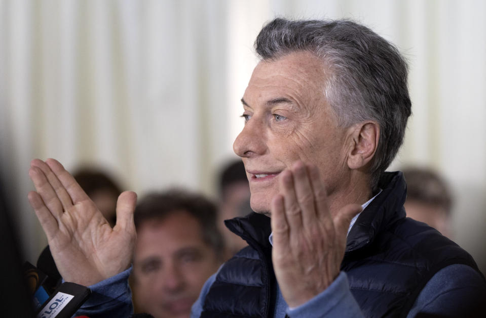 Argentina's President Mauricio Macri reacts as he talks to journalists after casting his vote during primary elections in Buenos Aires, Argentina, Sunday, Aug. 11, 2019. Macri is running for re-election with the "Juntos por el Cambio" party, in the Sunday primaries ahead of October's presidential election.(AP Photo/Tomas F. Cuesta )