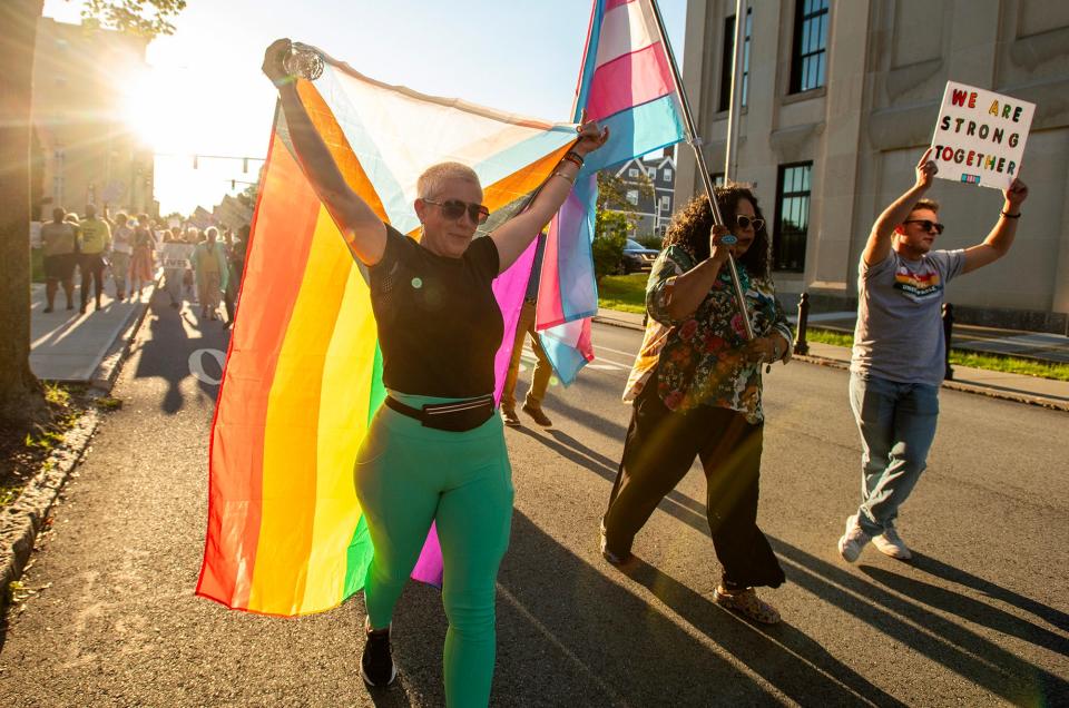 Karen Riley-McNary leads a group of protesters Wednesday from the Diocese of Worcester Chancery building to City Hall.