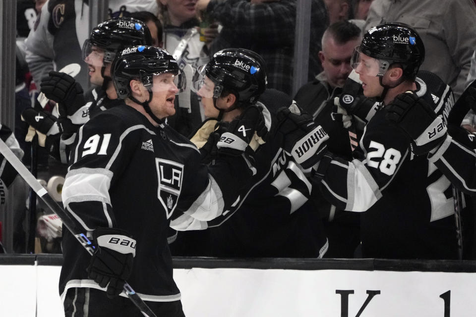 Los Angeles Kings right wing Carl Grundstrom (91) celebrates with teammates after scoring a goal during the first period of an NHL hockey game against the Montreal Canadiens, Saturday, Nov. 25, 2023, in Los Angeles. (AP Photo/Marcio Jose Sanchez)