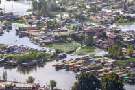 A view of the Dal Lake in Srinagar, Indian controlled Kashmir, Saturday, Aug. 28, 2021. Weeds, silt and untreated sewage are increasingly choking the sprawling scenic lake, which dominates the city and draws tens of thousands of tourists each year. (AP Photo/Mukhtar Khan)