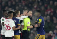 Referee Stuart Attwell, second right, discusses with players during the EFL Cup semifinal, first leg soccer match between Southampton and Newcastle United at St Mary's Stadium in Southampton, England, Tuesday, Jan. 24, 2023. (AP Photo/Kin Cheung)