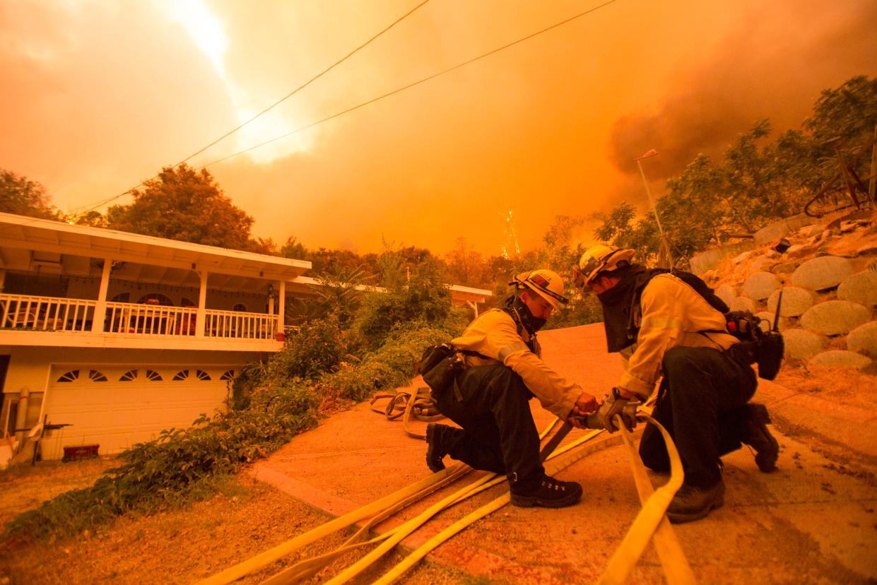 Firefighters battle the Lake Hughes fire in Angeles National Forest on Wednesday, Aug. 12, 2020, north of Santa Clarita, Calif.