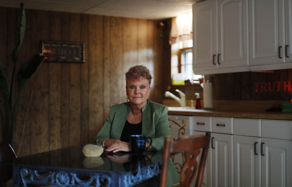 Truth Graf, 57, who served seven years in prison on a felony conviction in 2010, sits in her kitchen on election day in Woodstock, Ga., Tuesday, Nov. 6, 2018. Graf was convicted of arson and cocaine possession in what she calls "an act of desperation," when she burned her house down during the housing crisis to avoid foreclosure. Graf's right to vote won't be restored until she's off probation in 2040. She had voted before she went to prison. "I'll be 80 when I can vote again. It's devastating to me to be sitting here on election day," said Graf. "I believe so strongly in the process of having a voice and my voice has been taken away." (AP Photo/David Goldman)
