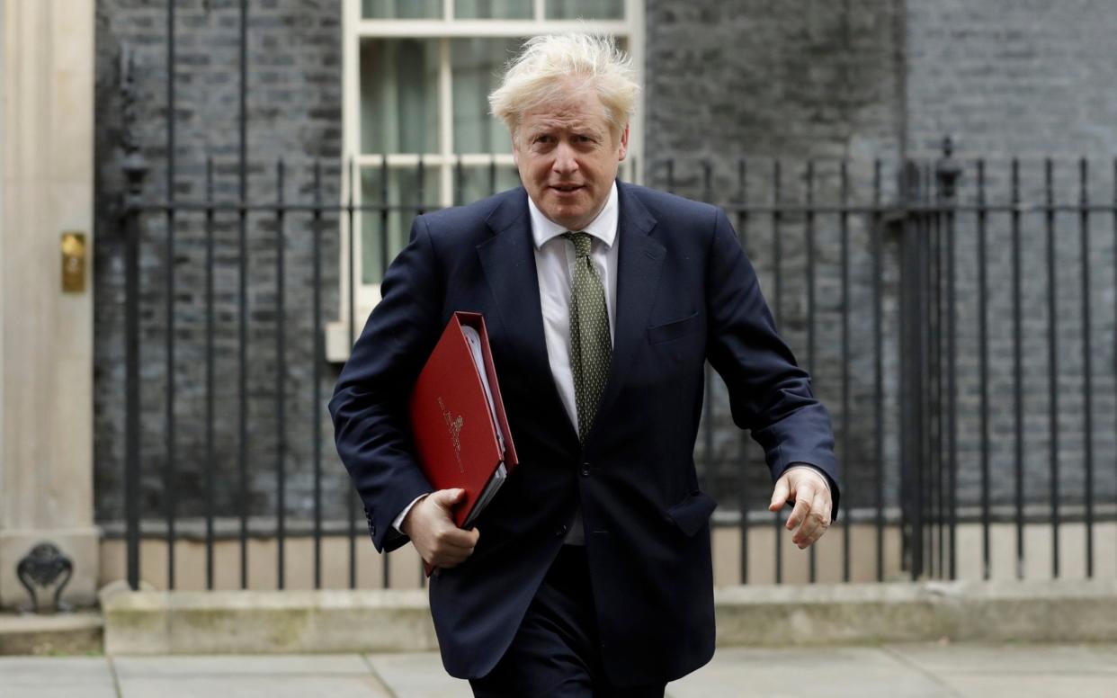 British Prime Minister Boris Johnson walks from 10 Downing Street to a meeting with his ministers at the Foreign Office, in London - Matt Dunham/AP