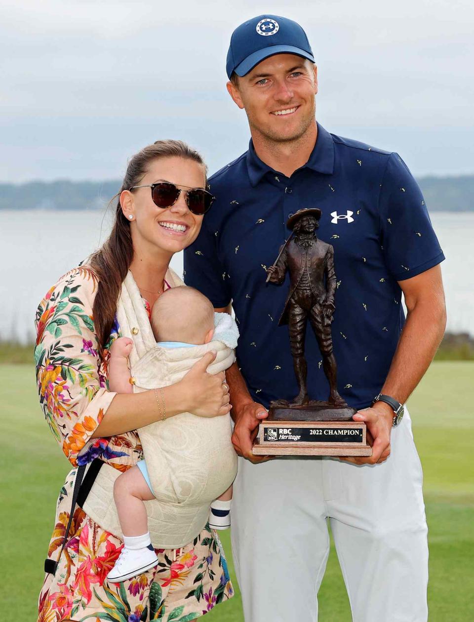 Jordan Spieth poses with the trophy with wife Annie Verret and son Sammy Spieth at Harbor Town Golf Links on April 17, 2022 in Hilton Head Island, South Carolina