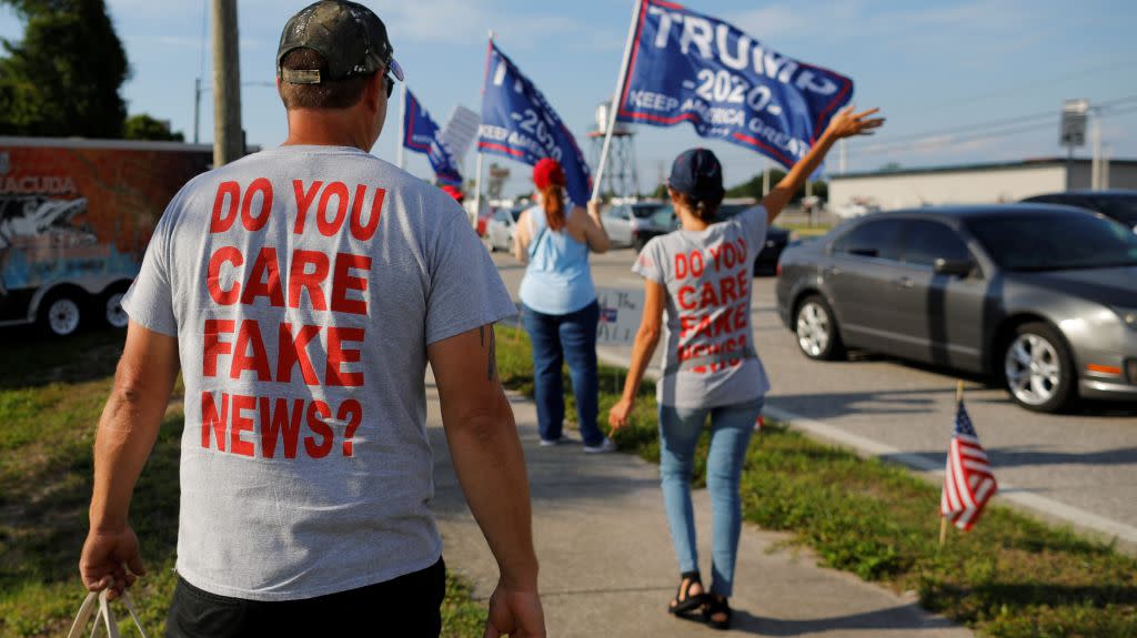 A man wears a t-shirt saying Do you care, fake news?