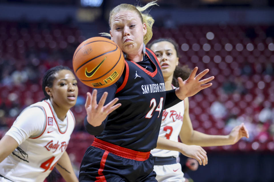 San Diego State guard Abby Prohaska (24) attempts to gather in a pass against UNLV during the first half of an NCAA college basketball game for the championship of the Mountain West women's tournament Wednesday, March 13, 2024, in Las Vegas. (AP Photo/Ian Maule)