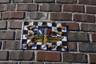 John and Susan Skelton take a photo of a race flag outside of the Indianapolis Motor Speedway, Thursday, Aug. 20, 2020, in Indianapolis. (AP Photo/Darron Cummings)