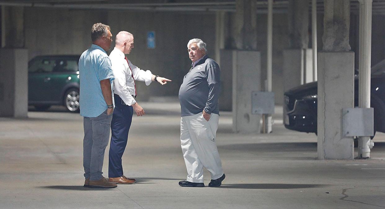 Norfolk County District Attorney Michael Morrissey, right, gets information from detectives at 5 Crown Drive on Thursday, Aug. 18, 2022.