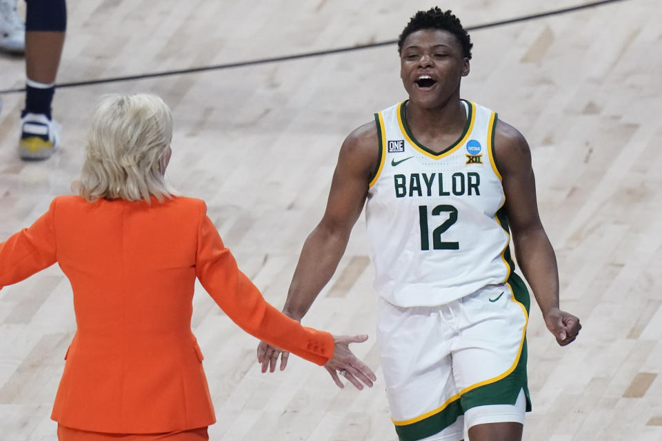 Baylor guard Moon Ursin (12) and head coach Kim Mulkey celebrate the team's overtime win over Michigan in a college basketball game in the Sweet Sixteen round of the women's NCAA tournament at the Alamodome in San Antonio, Saturday, March 27, 2021. (AP Photo/Eric Gay)