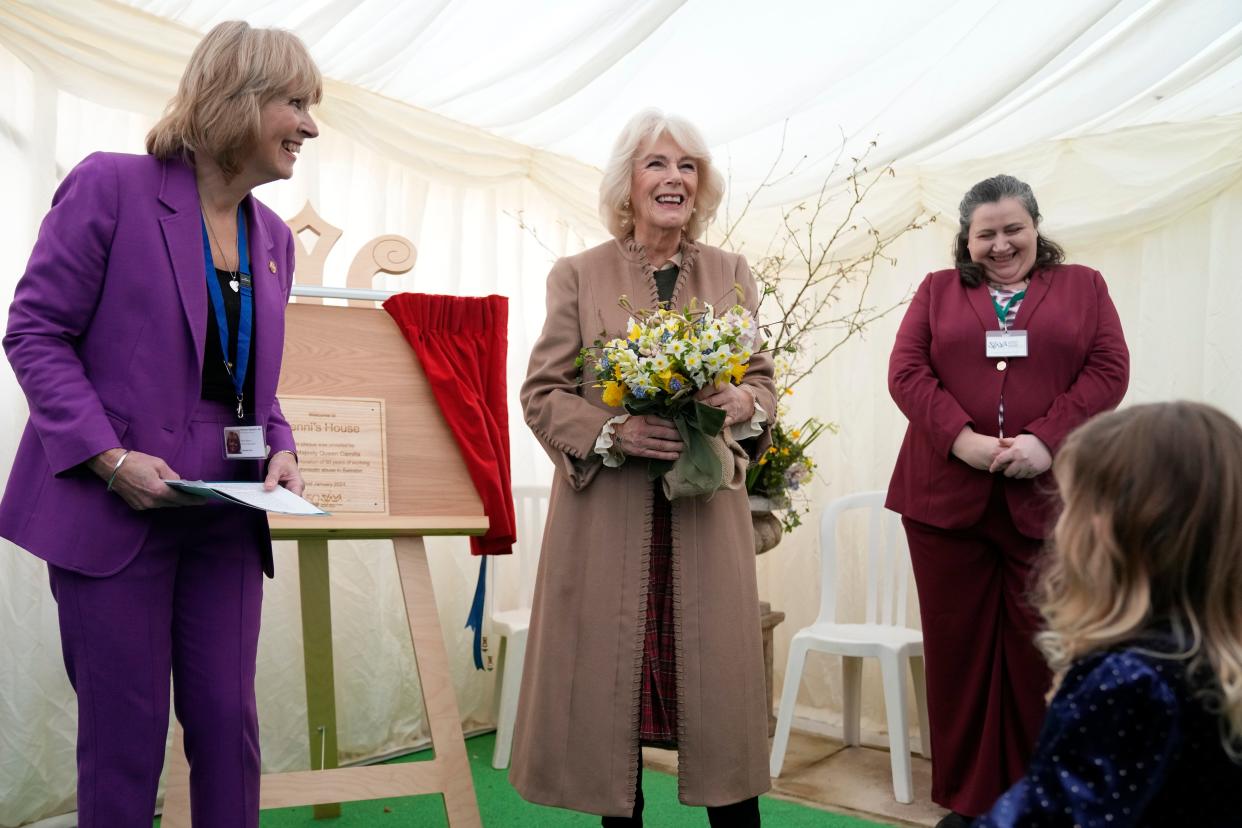 Queen Camilla smiles after unveiling a plaque during a visit to a women's refuge in Swindon, England, last month. In the years she's been married to King Charles, she's taken an active role in charitable causes on behalf of the royals.