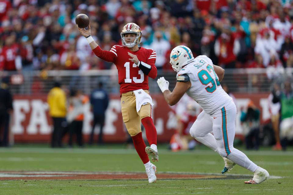 San Francisco 49ers quarterback Brock Purdy, left, passes against Miami Dolphins defensive tackle Zach Sieler during the first half Sunday.