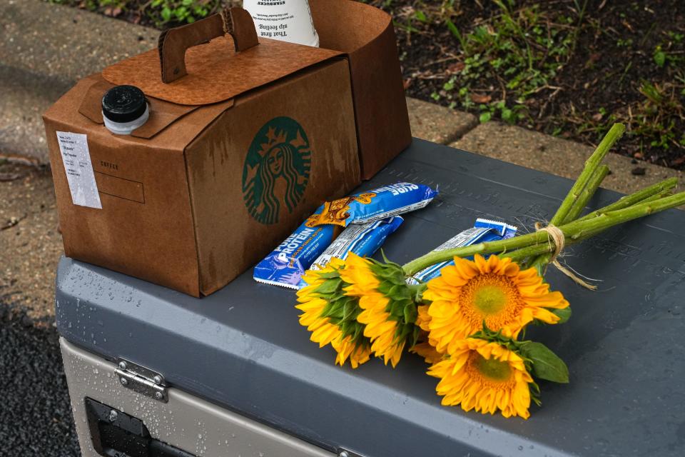 Flowers, coffee and protein bars are left on an ice chest Saturday for officers investigating a South Austin home where four people, Austin police SWAT officer Jorge Pastore, died last weekend.