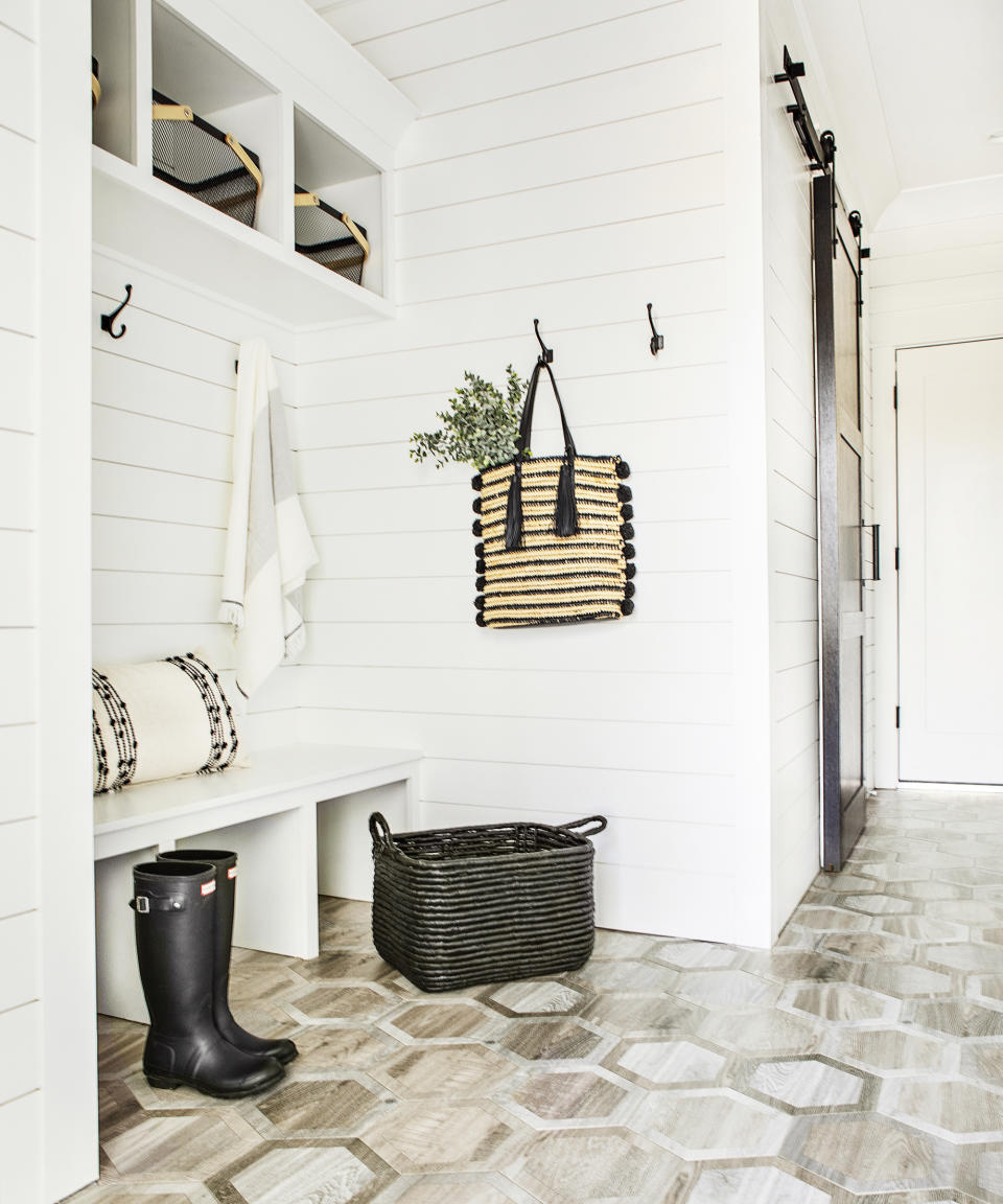 Modern entryway bench ideas with white shiplap walls, boot bench built into alcove with shelves above head height