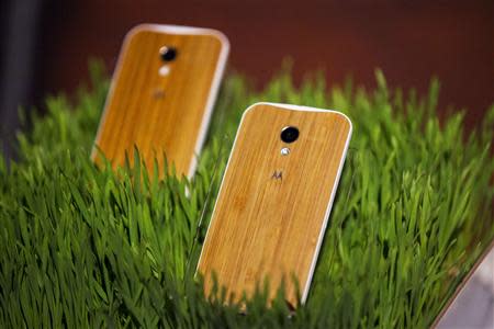 Phones with wooden backs on them rest in a display at a launch event for Motorola's new Moto X phone in New York, in this August 1, 2013 file photo. REUTERS/Lucas Jackson/Files