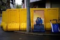 Painted power box is seen near barricades built up to block residential buildings from streets in Wuhan