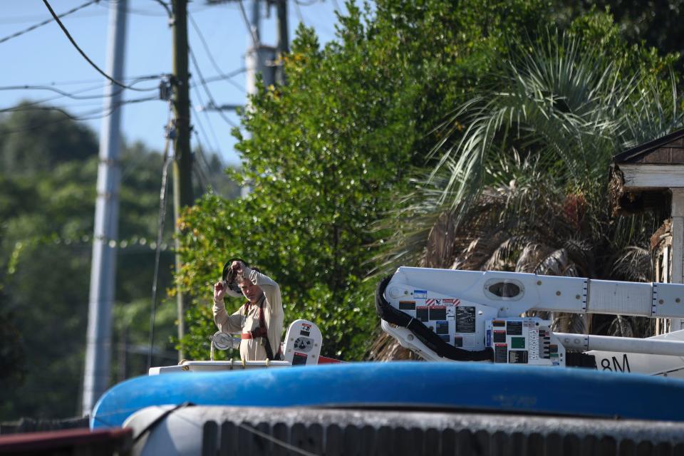 Workers with WideOpenWest, AT&T, and Georgia Power work to move power lines around the historic Fordyce-Kennedy-Pritchard House so it can be moved from McDowell Street to its new location on East Avenue on Thursday, Sept. 7, 2023.