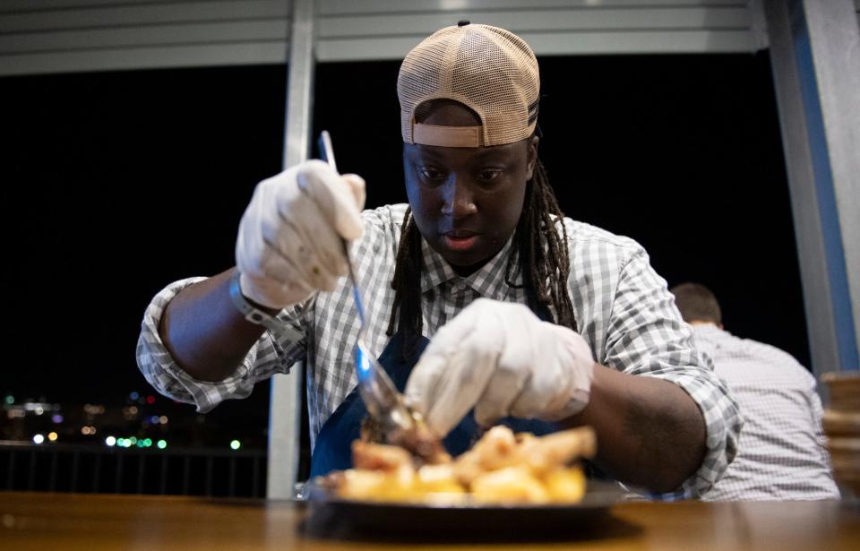 Torrece "Chef T" Gregoire, from Ina + Forbes in St. Paul, Va., makes a dish called "Sunday Supper" during the euphoria event, "Taste of the South"  held at Fluor Field Friday, Sept 20, 2019.