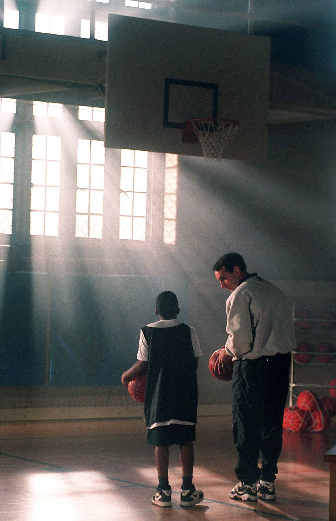 Knightdale’s Travis Williams, 10, gets a little instruction from Duke head coach Mike Krzyzewski in Card Gym in 1997 as they filmed an Ad for the American Cancer Society.