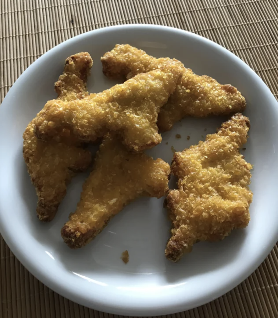 Dino chicken nuggets on a plate.