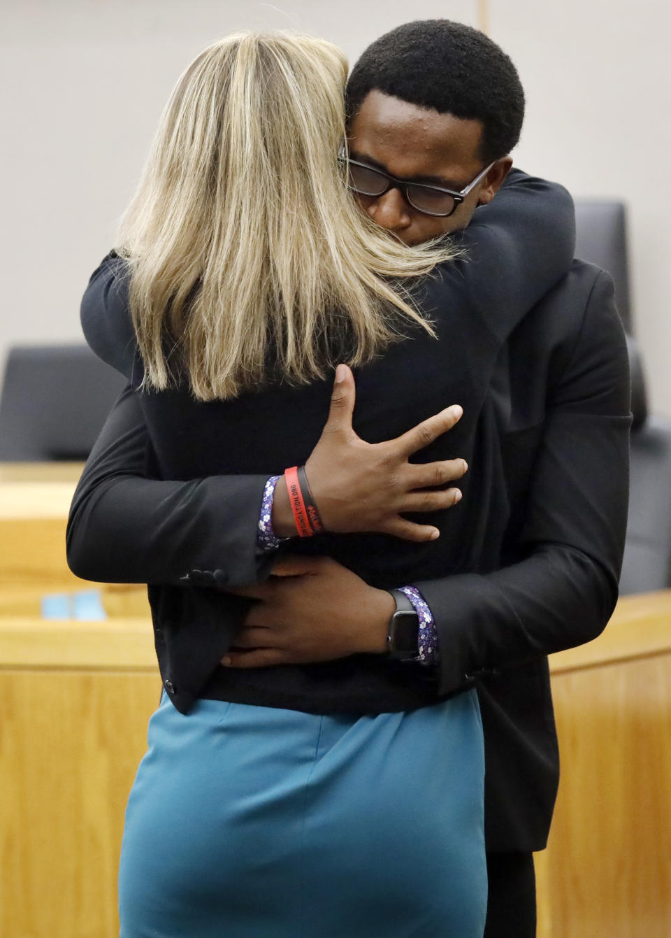 Botham Jean's younger brother Brandt Jean hugs former Dallas police officer Amber Guyger after delivering his impact statement to her in Dallas, Wednesday, Oct. 2, 2019. Guyger has been sentenced to 10 years in prison for killing her black neighbor in his apartment, which she said she mistook for her own unit one floor below. (Tom Fox/The Dallas Morning News via AP, Pool)