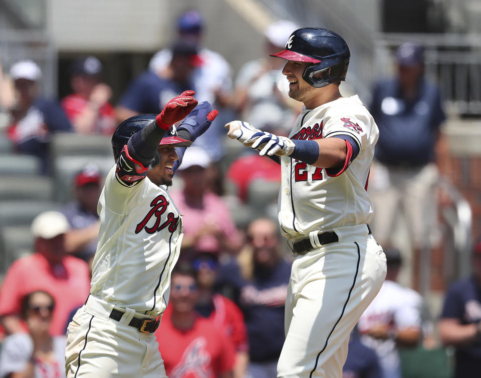 Atlanta Braves' Austin Riley, right, celebrates after hitting his second home run with teammate Ozzie Albies, left, during the third inning of a baseball game against the Pittsburgh Pirates, Sunday, May 23, 2021, in Atlanta. (Curtis Compton/Atlanta Journal-Constitution via AP)