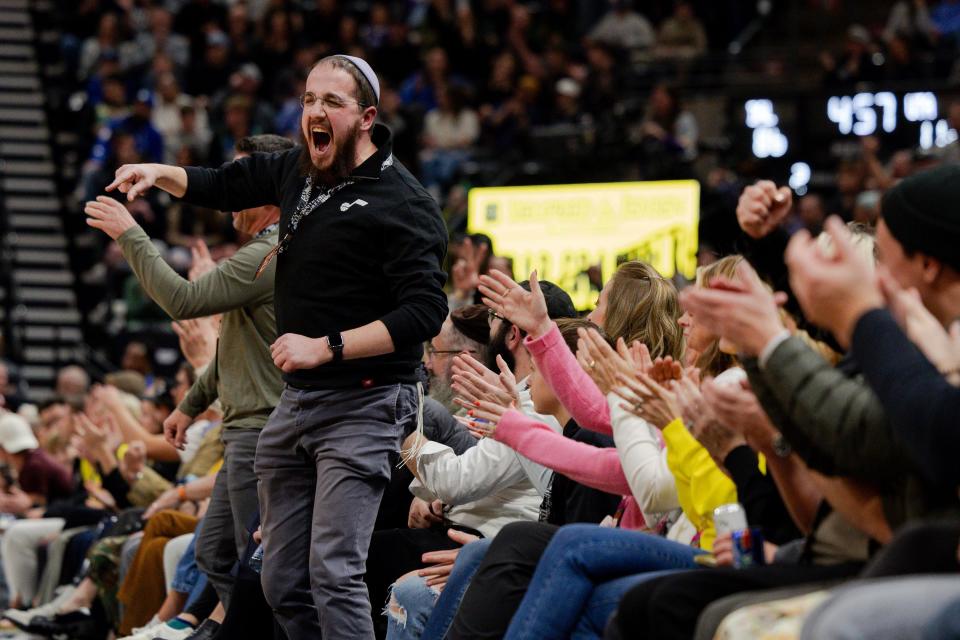 Jazz fans cheer during the fourth quarter of the NBA basketball game between the Utah Jazz and the Dallas Mavericks in Salt Lake City on Jan. 1, 2024.