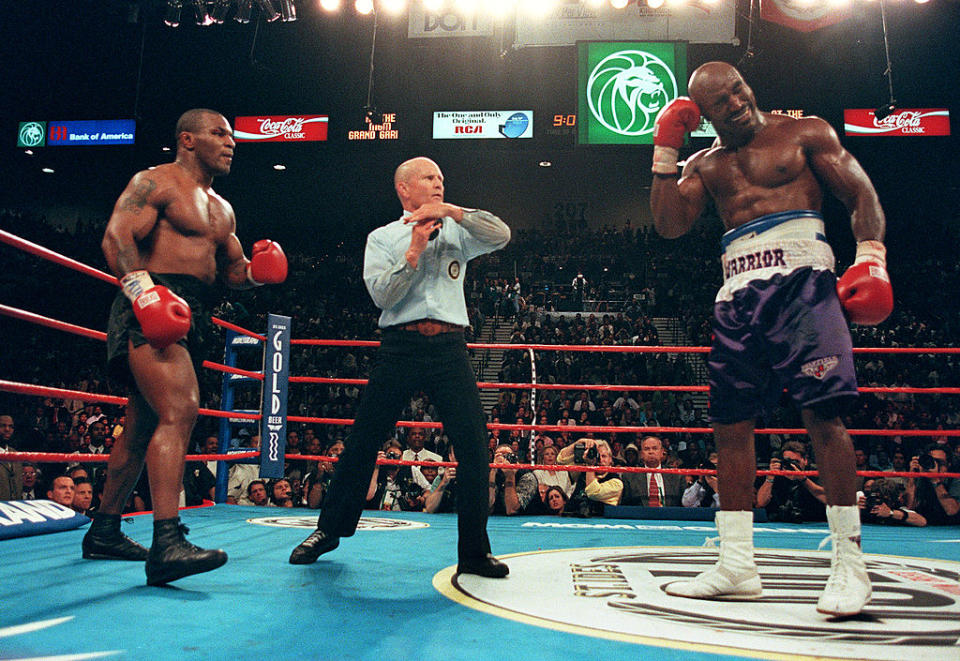 The referee stops the fight between Mike Tyson, left, and Evander Holyfield after Tyson bit Holyfield&#39;s ear during their bout on June 28, 1997, at the MGM Grand Garden Arena in Las Vegas. (Photo: JEFF HAYNES/AFP via Getty Images)