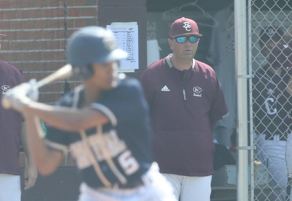 Benedictine head coach Kevin Farmer watches from the dugout during a recent playoff game against Thomas County Central.
