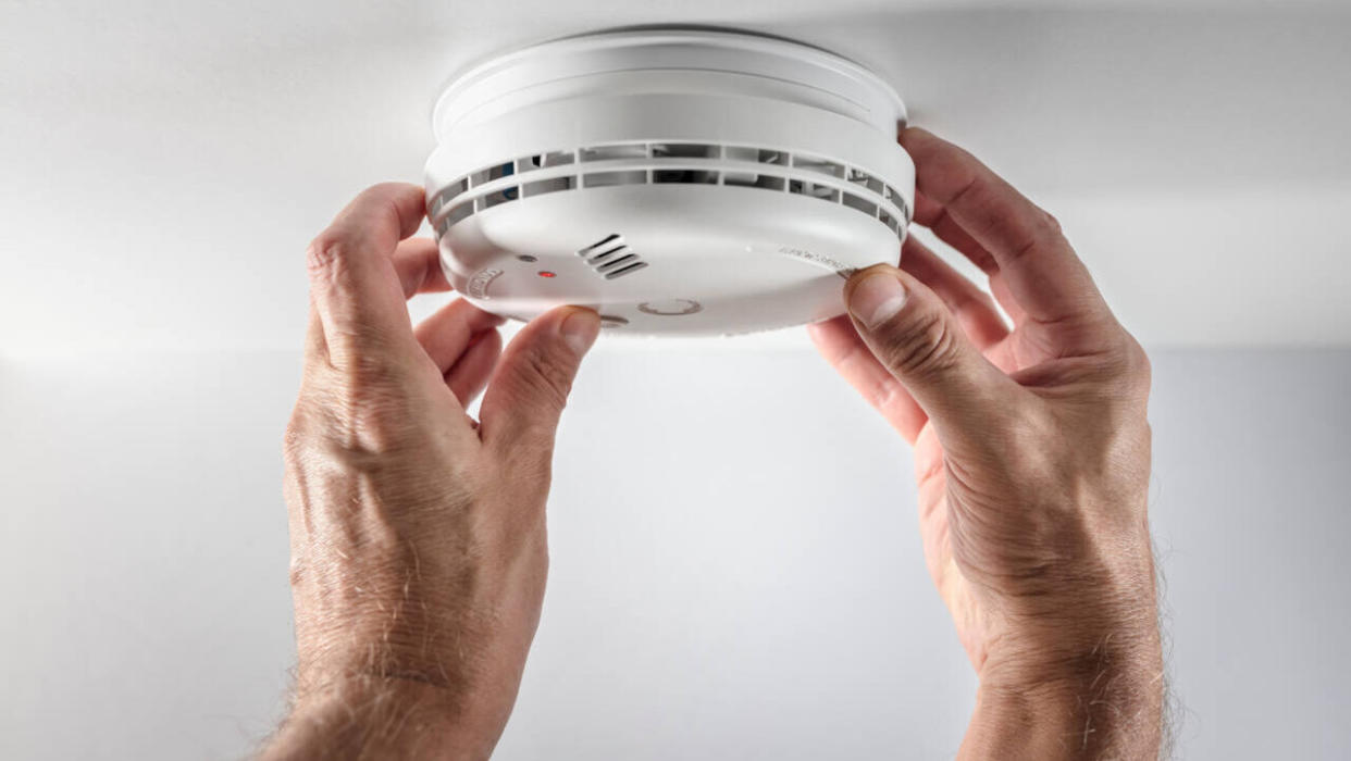 Man installing a new smoke alarm